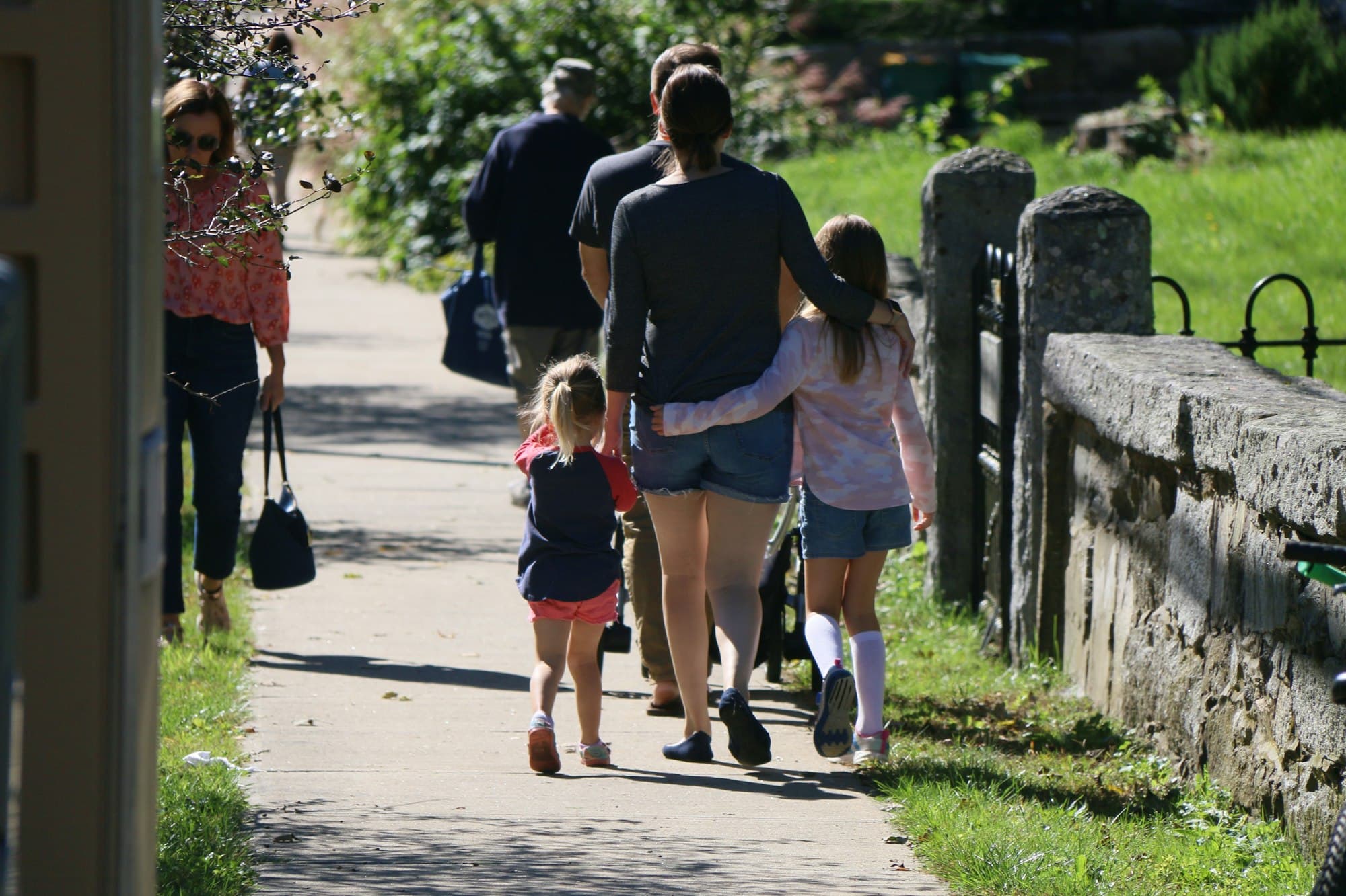 A family walking together down a sidewalk