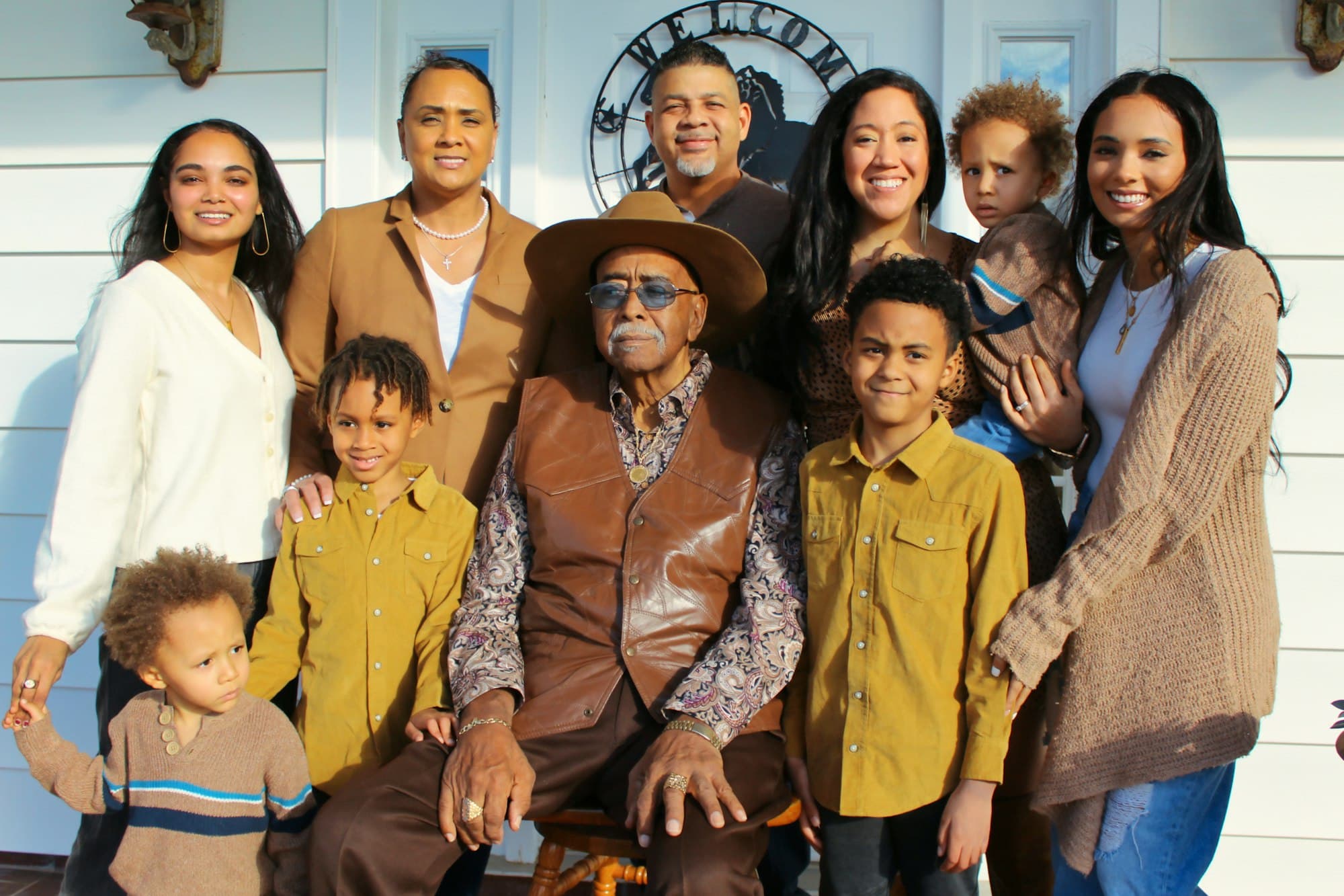A large multigenerational family gathered together on a porch